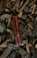 Bully pizzle chew laying on a bed of wood chips