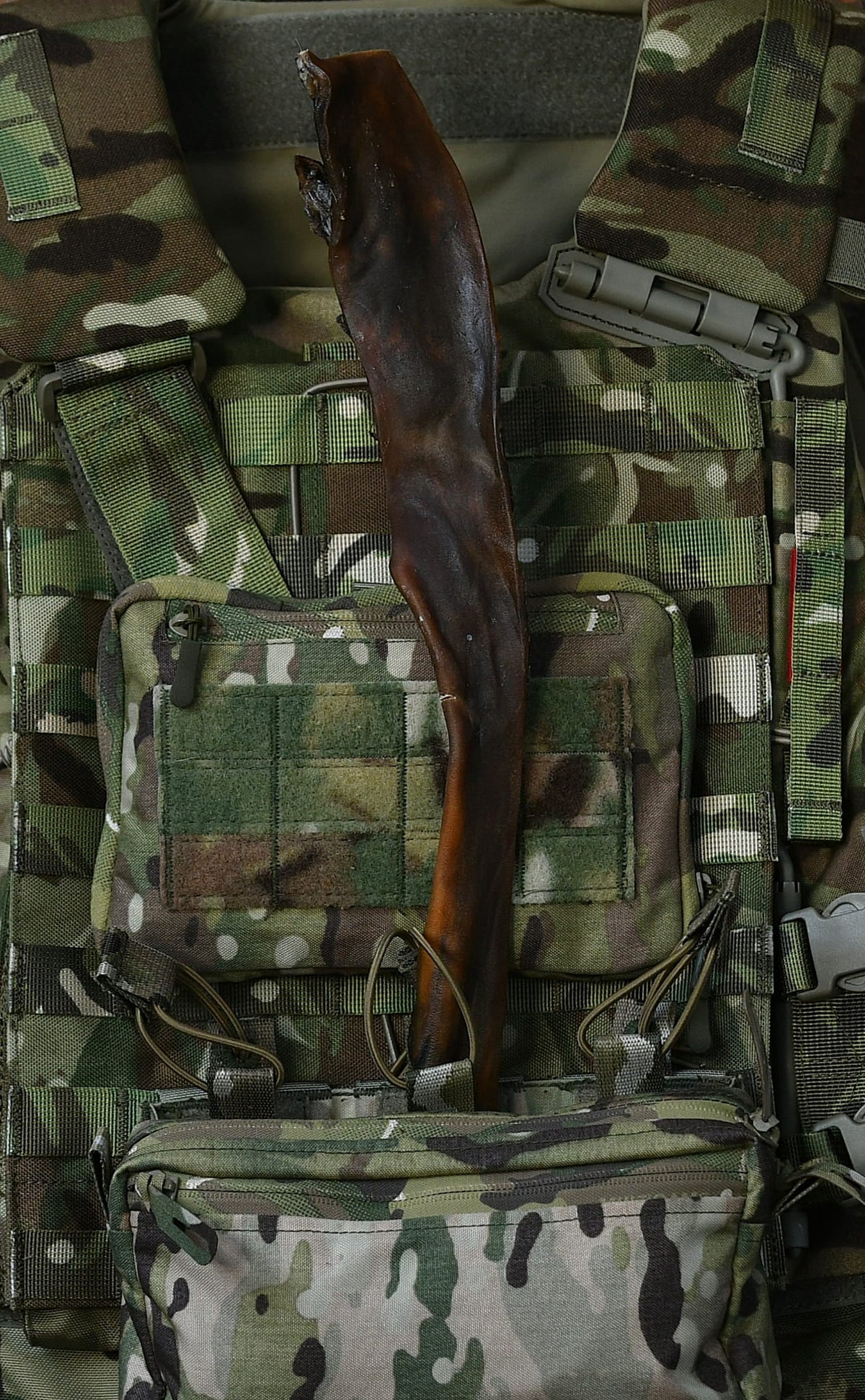 Jumbo venison skin dog chew displayed in a camouflage tactical vest.
