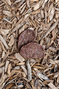 Lamb grills dog treats on natural wood chips