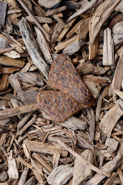 Beef and shrimp steak dog treats on natural wood chips